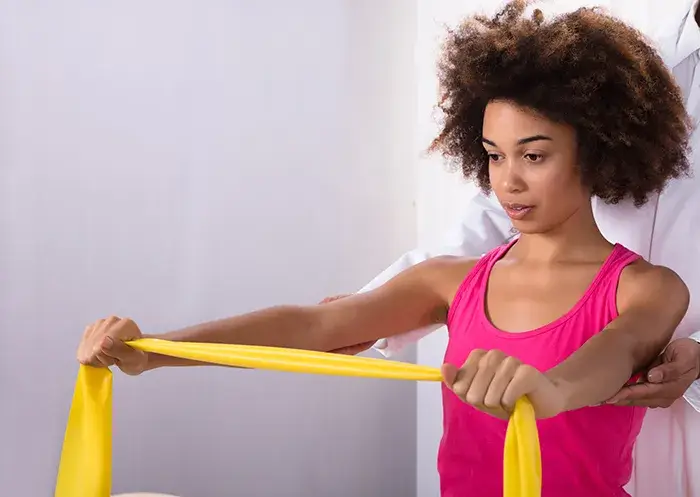 attractive lady using stretching band for exercise