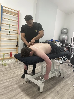 darnell bailey giving man a physiotherapy treatment massage on table in treatment room