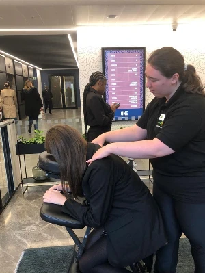 a massage demonstration in massage chair out and about