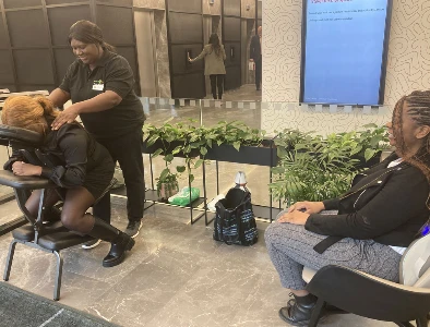 lady having a massage in chair with another patient waiting