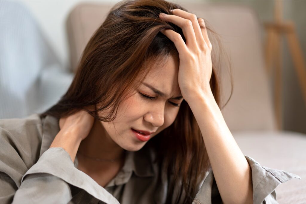 Headaches & Migraines 10 female employee sitting on the floor to touching f 2024 10 16 09 33 34 utc converted